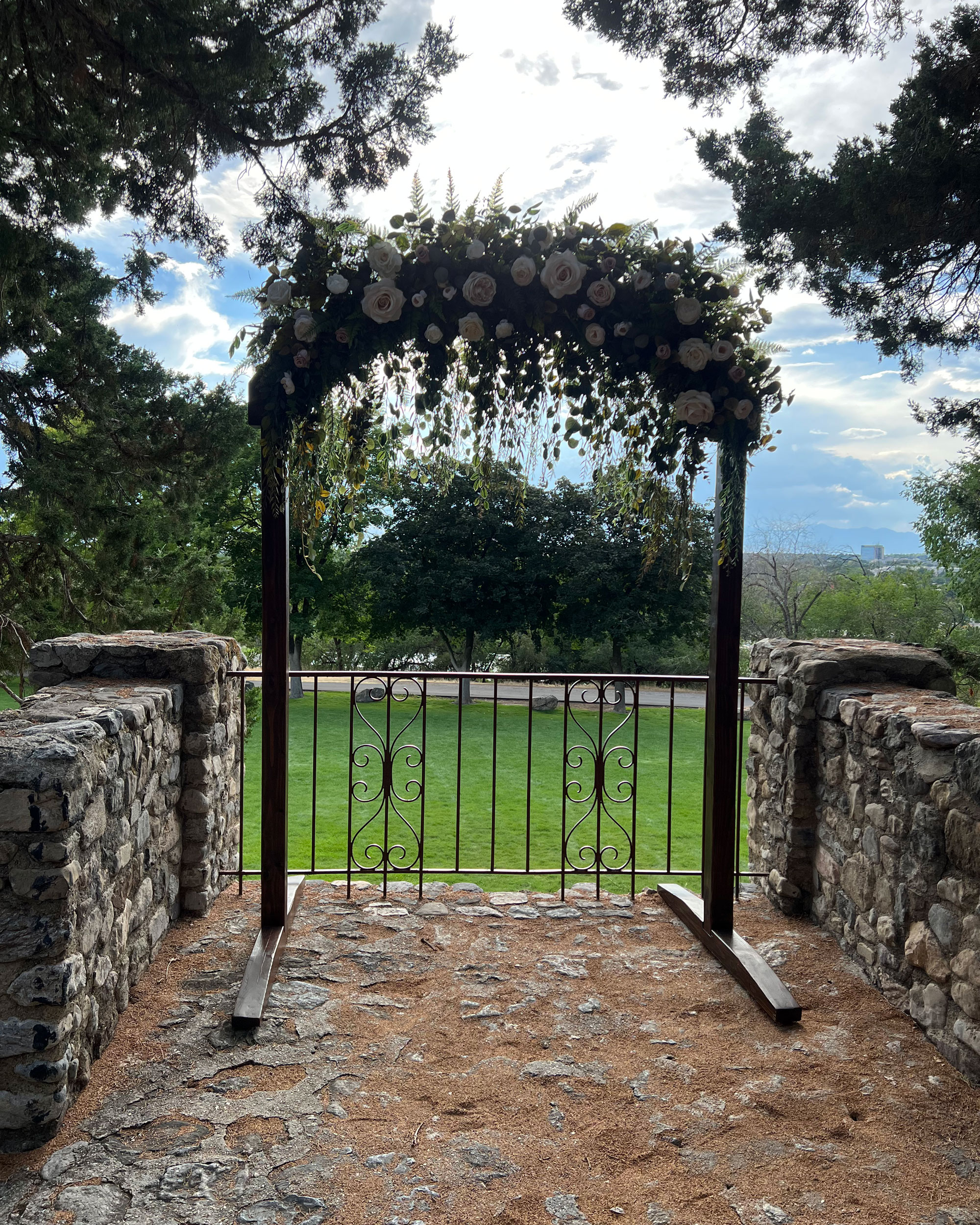 Proposal featuring Cascading Vines Tan Ivory Floral Wedding Arch at Castle Amphitheater in Provo, Utah.