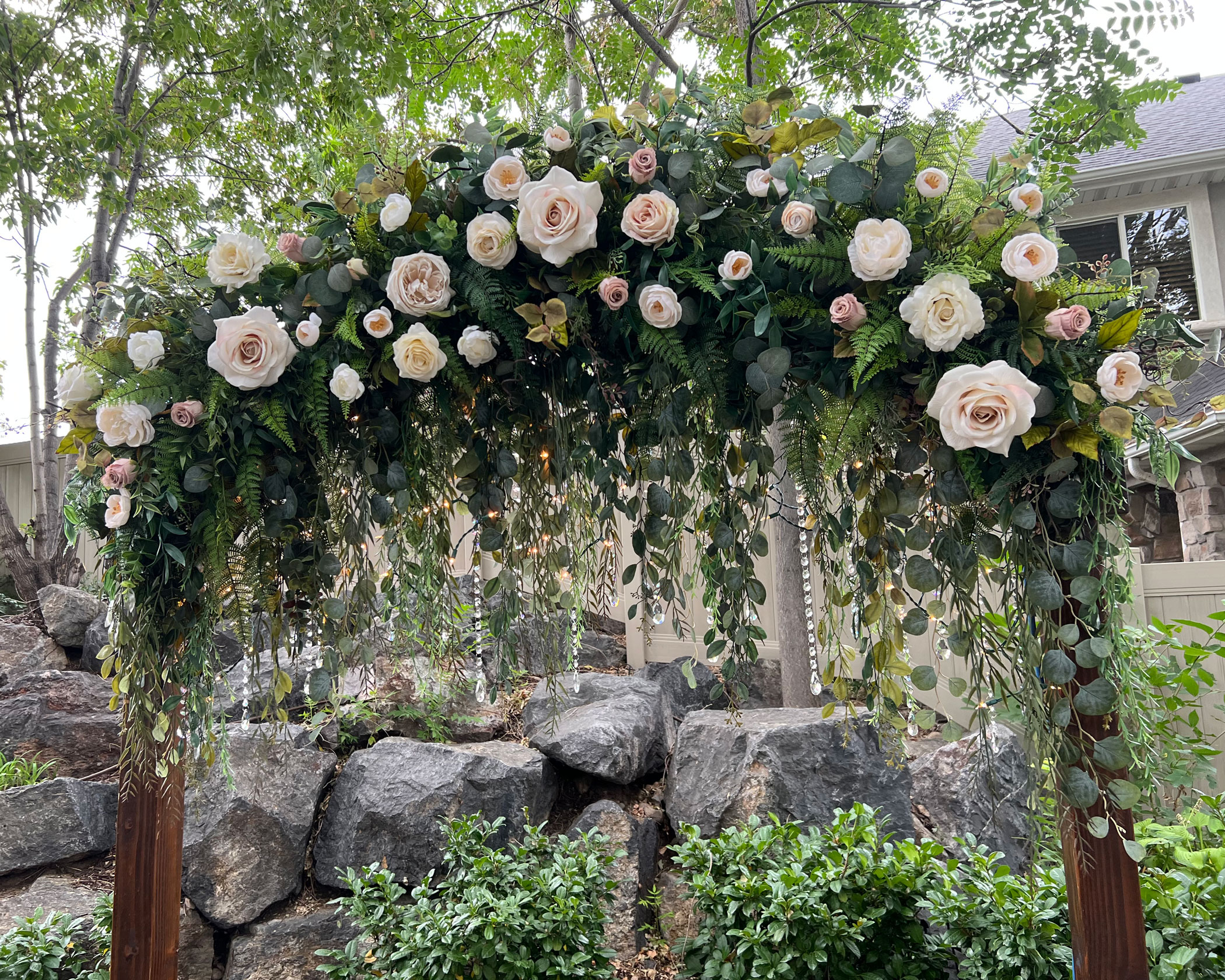 Reception featuring Cascading Vines Tan Ivory Floral on Classic Dark Wedding Arch at Clarion Gardens in Payson, Utah.