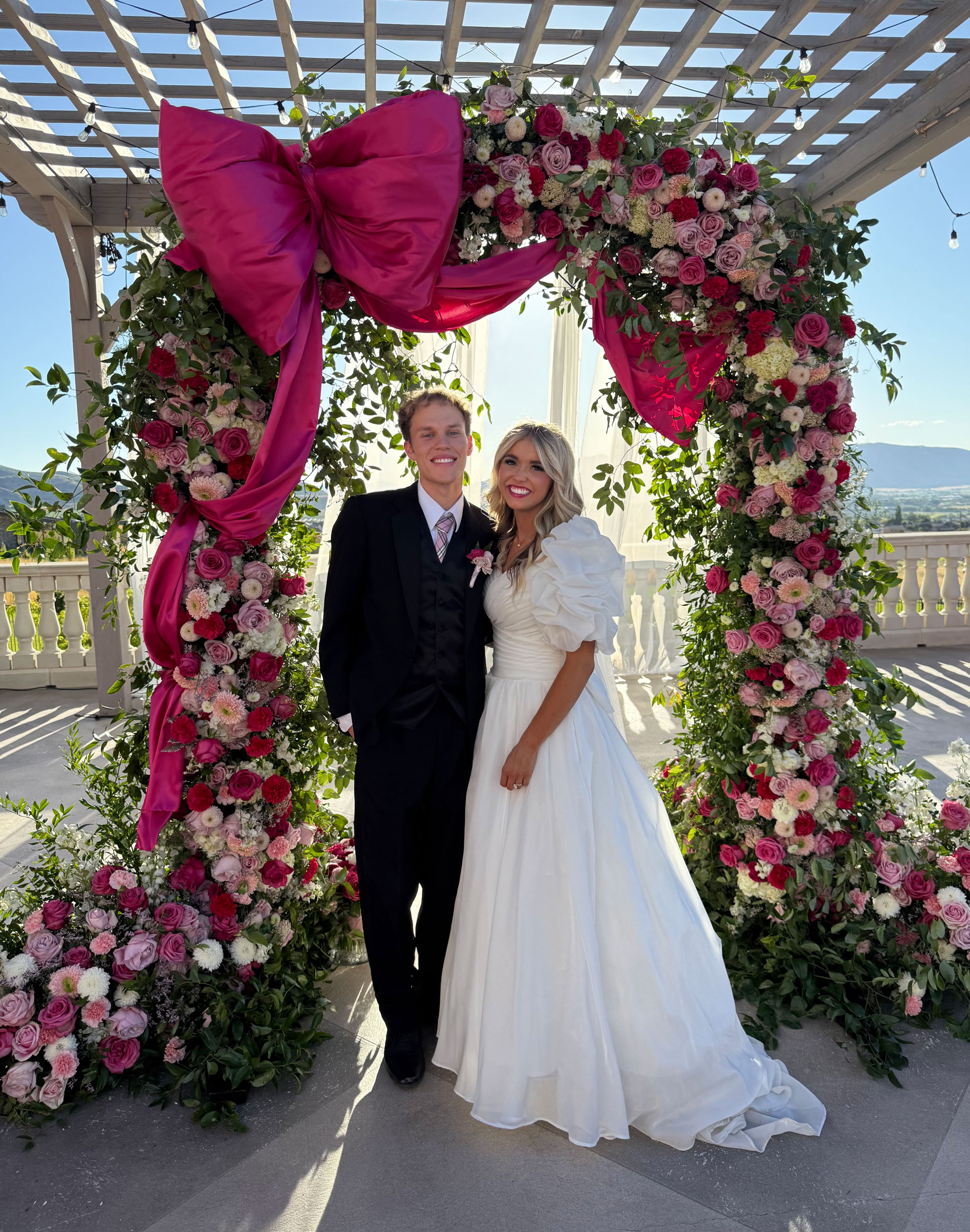 Reception featuring DIY Fresh Flowers Wedding Arch at home backyard in Elkridge, Utah.