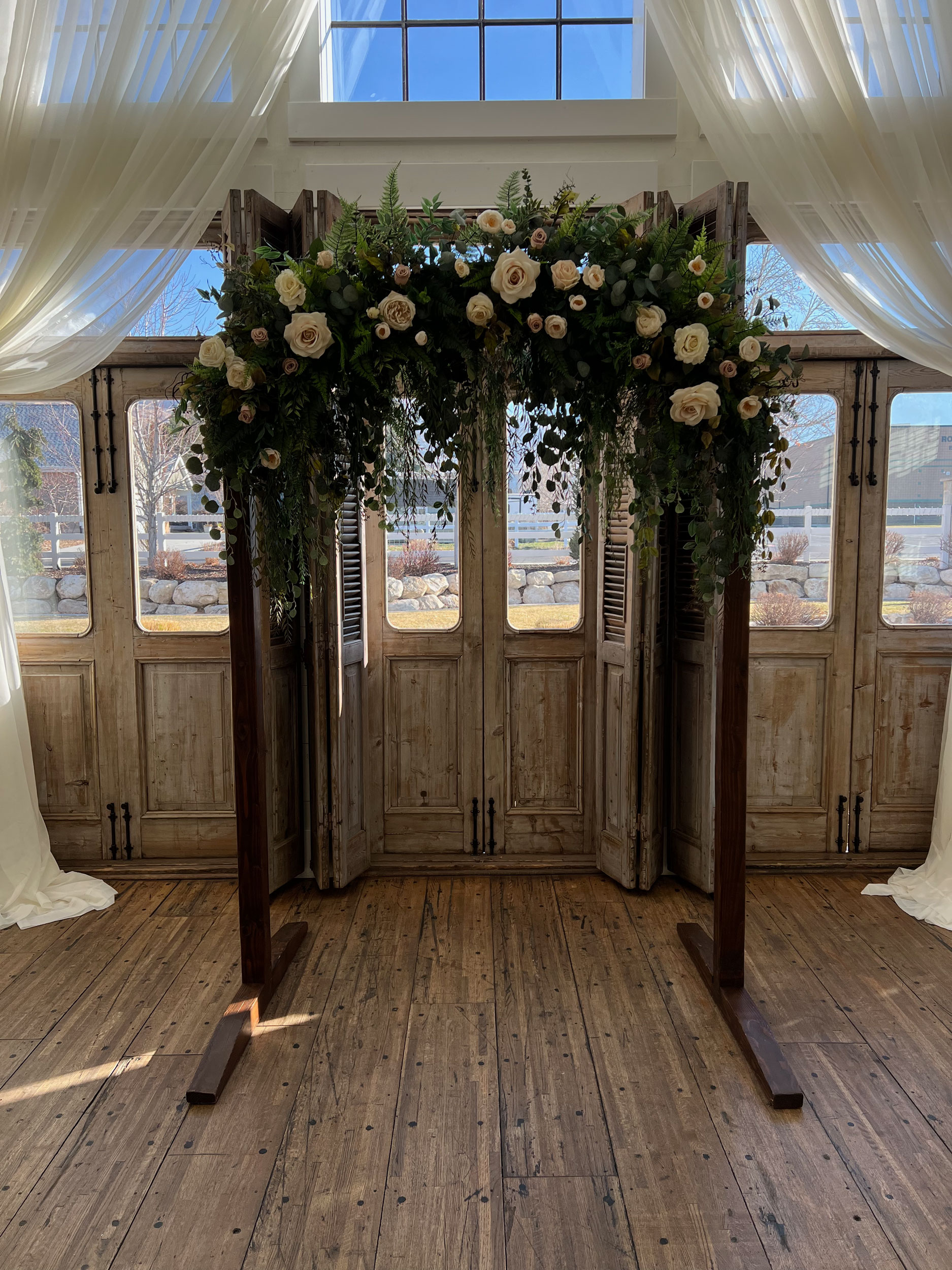 Reception featuring Cascading Vines Tan Ivory Floral Wedding Arch at Walker Farms in Lindon, Utah.