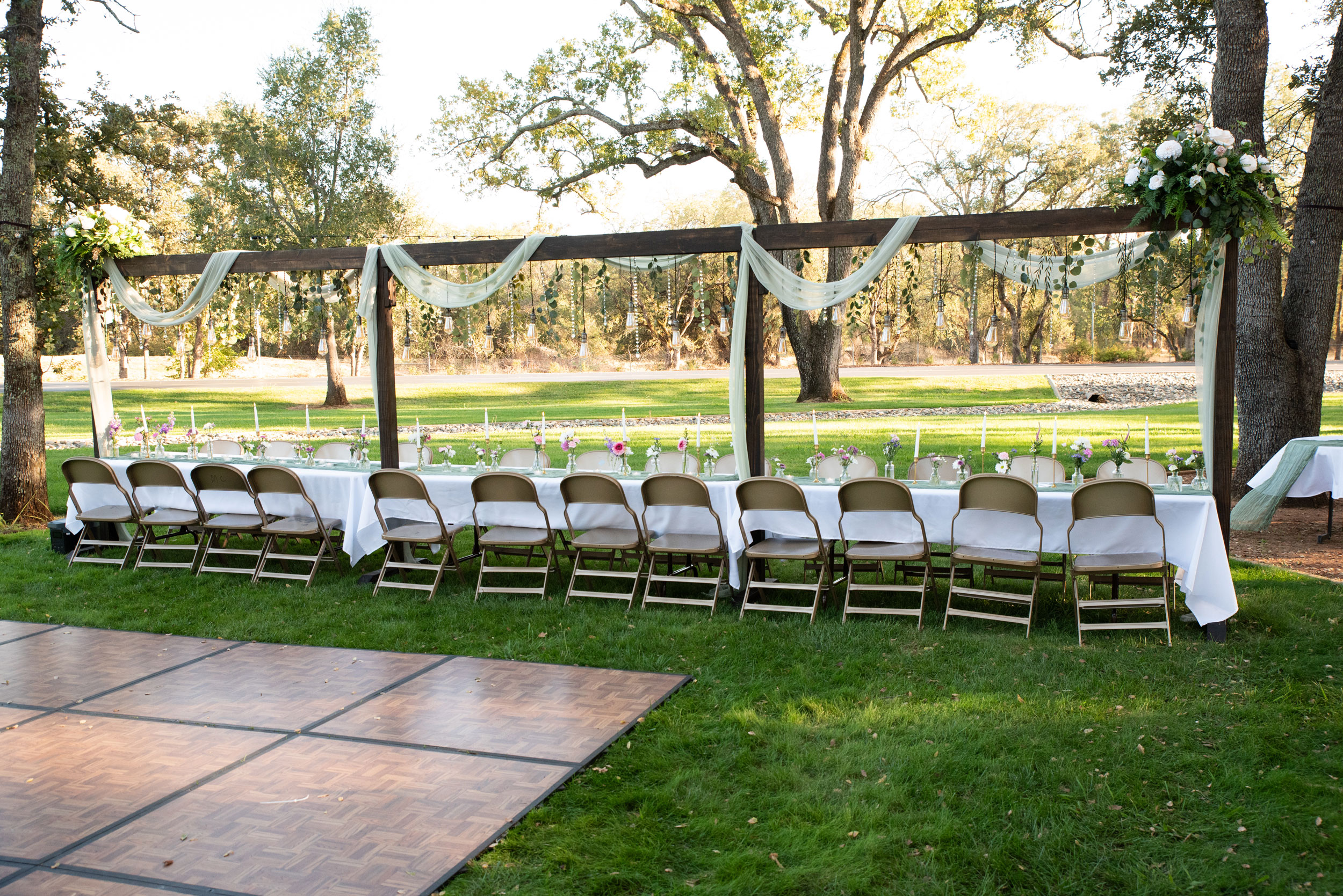 Wedding Reception featuring Wildflower Floral Lighted Table Arches at Rancho Cordova Park in Carmichael, California.