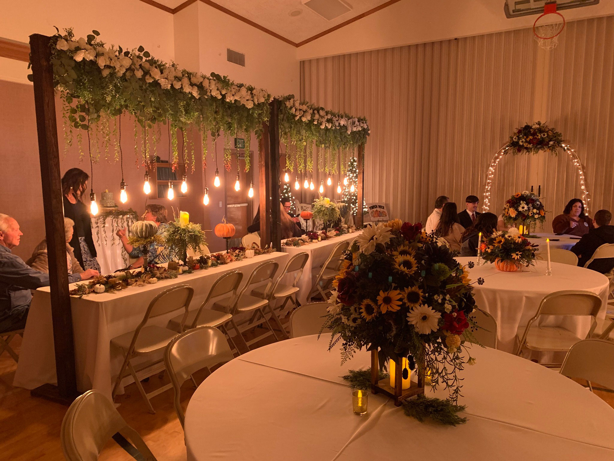 Wedding Reception featuring Fall Sunflower Floral Lighted Table Arches at LDS Chapel in Spanish Fork, Utah.