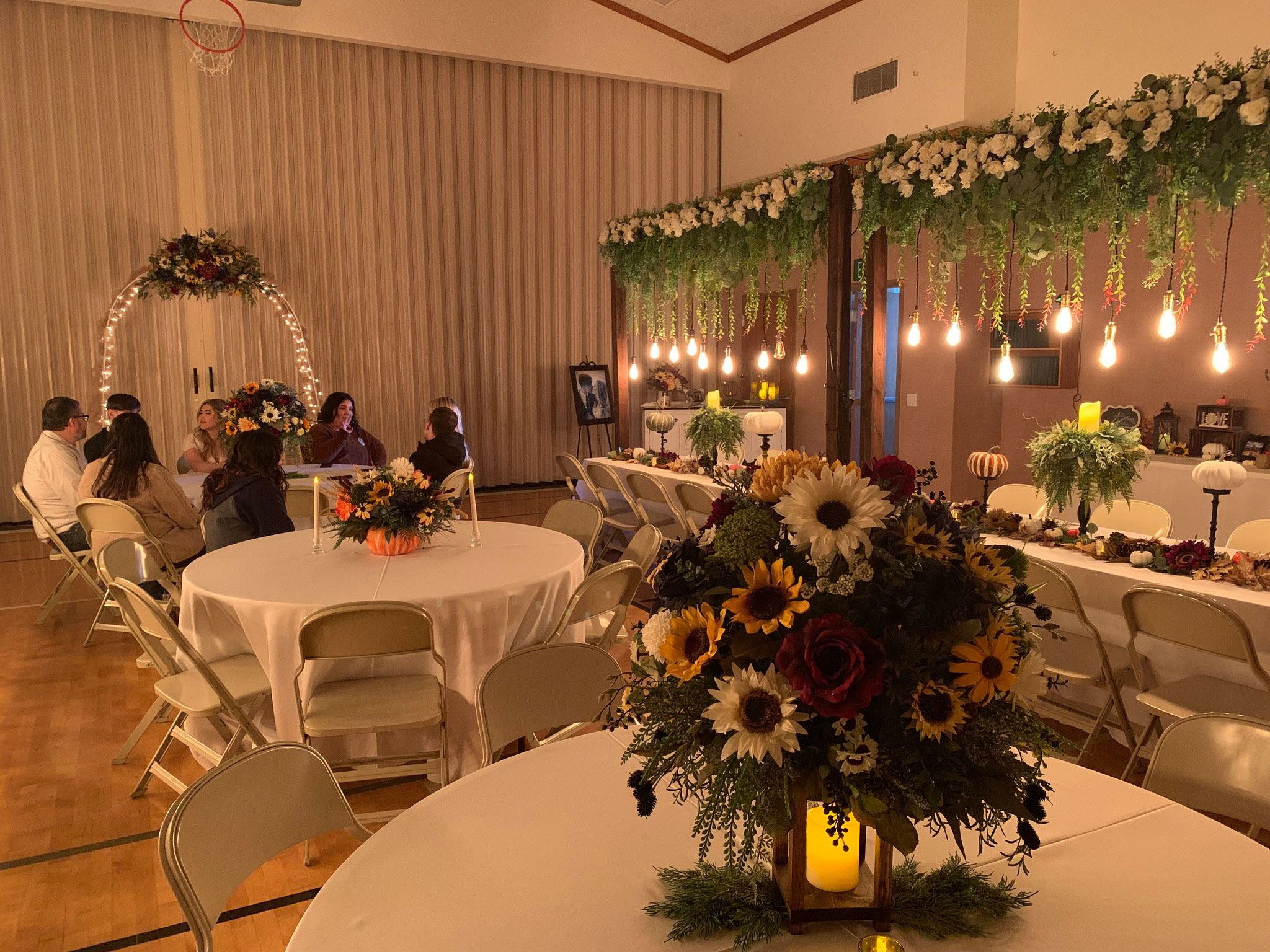 Wedding Reception featuring Fall Sunflower Floral Lighted Table Arches at LDS Chapel in Spanish Fork, Utah.