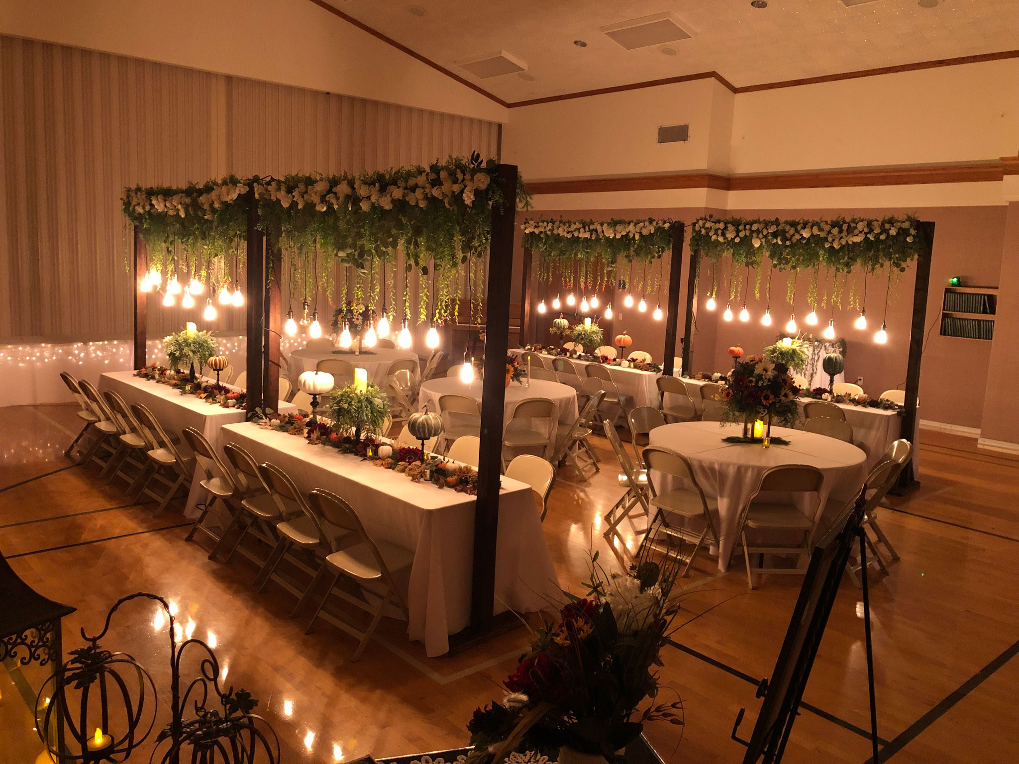 Wedding Reception featuring Fall Sunflower Floral Lighted Table Arches at LDS Chapel in Spanish Fork, Utah.