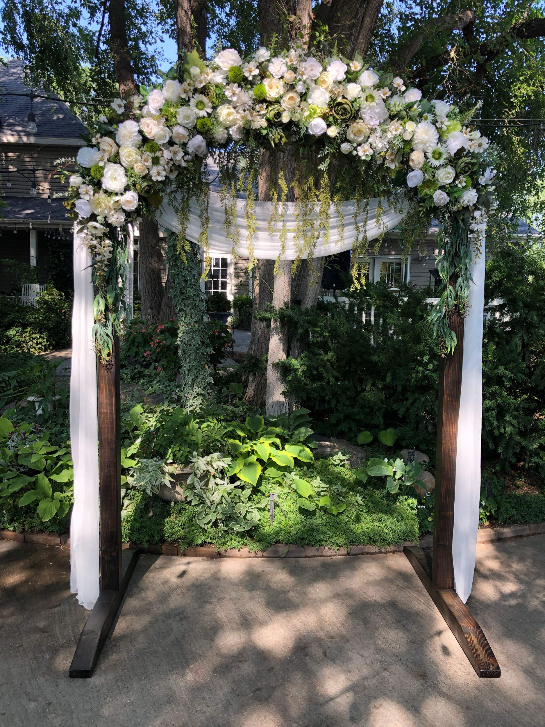 Wedding Reception featuring White Ivory Floral Wedding Arch at Clarion Gardens in Payson, Utah.